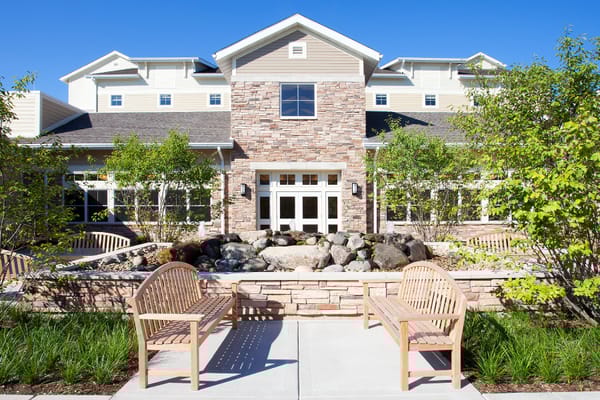 Exterior view of a senior living facility with landscaping