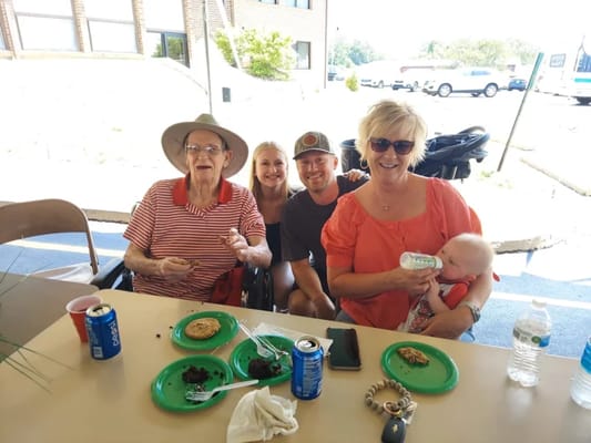 Residents and family enjoying cookies outdoors