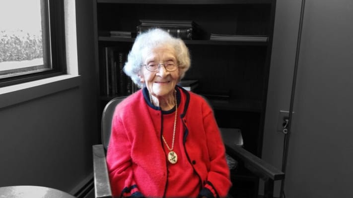 Senior resident smiling in a cozy indoor setting