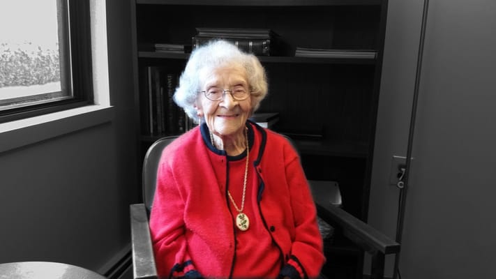 Senior resident smiling in a cozy indoor setting