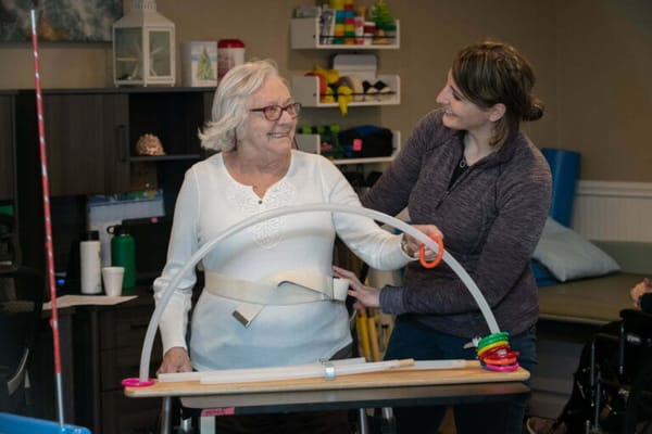 A resident receiving assistance in an activity session