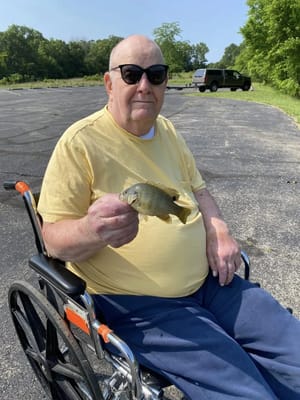 Resident fishing while seated in a wheelchair