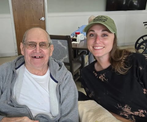 Resident enjoying time with staff member in a common area