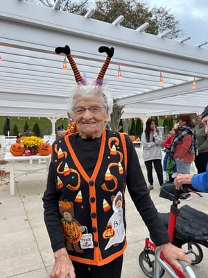Resident in a festive Halloween sweater with decorations