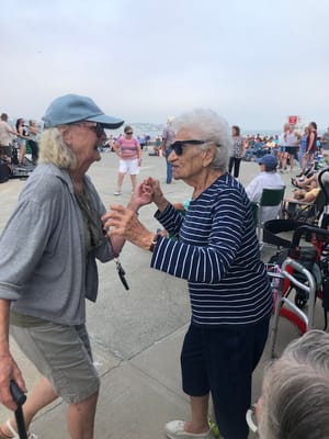 Residents enjoying a lively dance at an outdoor event