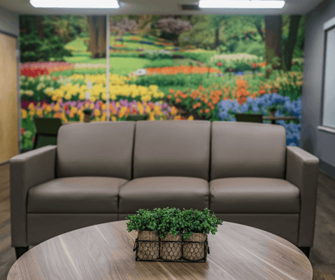 Interior lounge area with floral mural backdrop