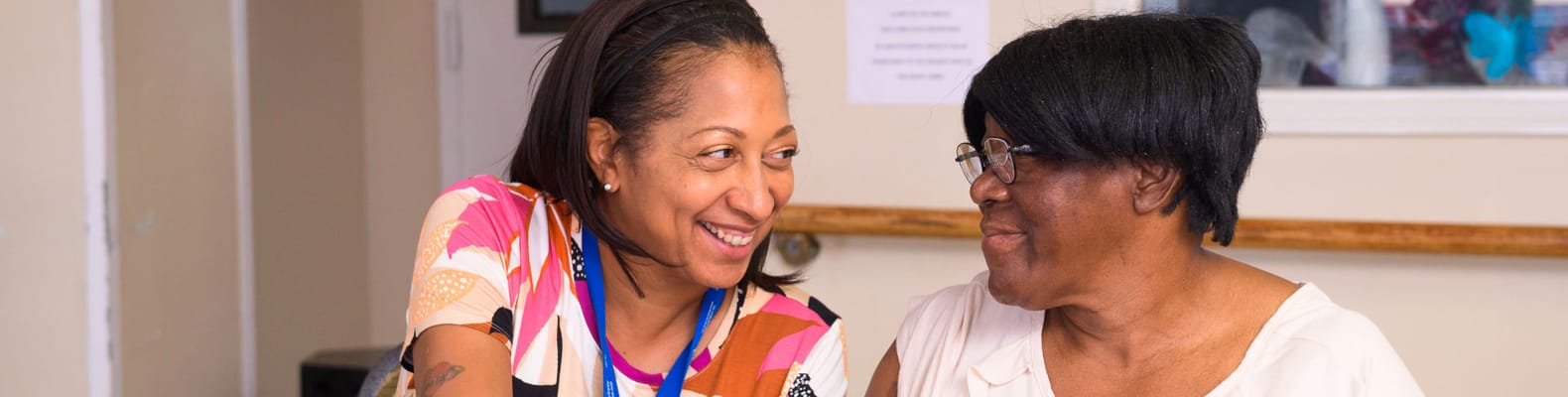 Staff member engaging with a resident in an activity