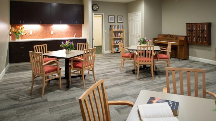 Bright common area with seating and bookshelf