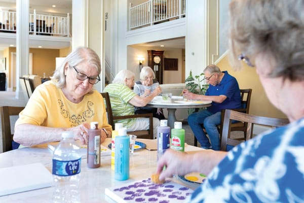 Residents engaged in an arts and crafts activity in a common area