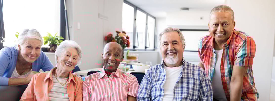 Residents smiling together in a sunny common area