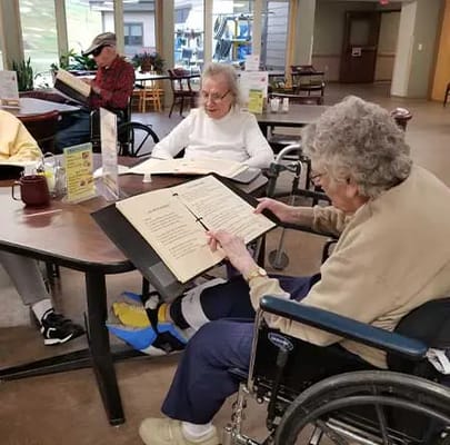 Residents reading menus in the dining room