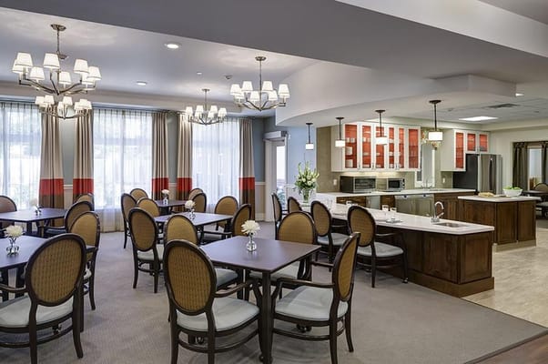 Bright dining room with tables and chairs set for meals