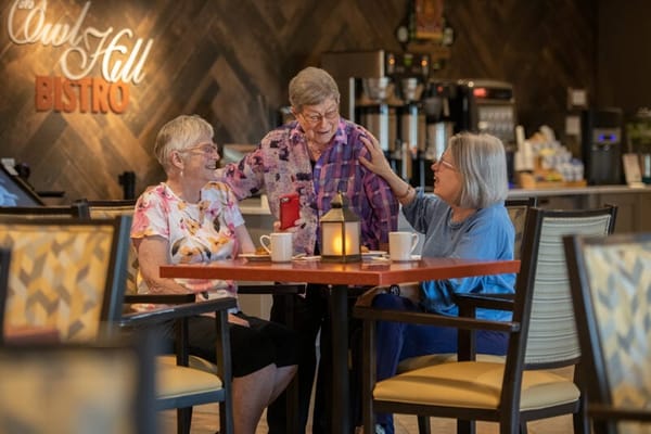 Residents enjoying coffee at a bistro table