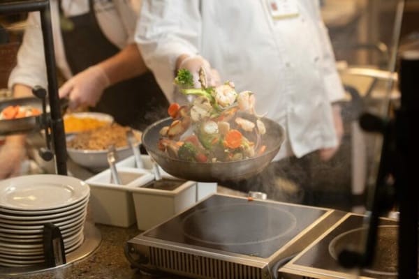 Chef preparing a colorful stir-fry in the kitchen