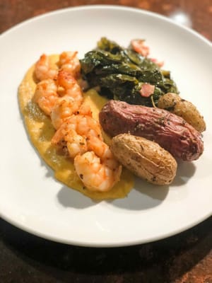 A plated meal with shrimp and vegetables