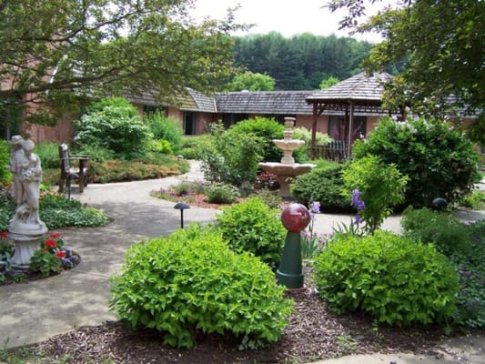 Lush garden area with seating and pathways