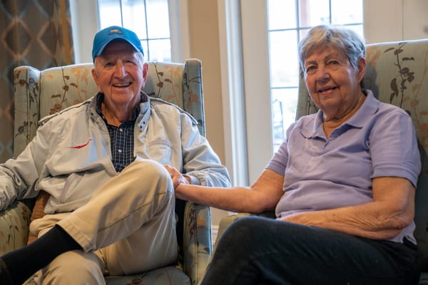 Two residents smiling in a cozy common area
