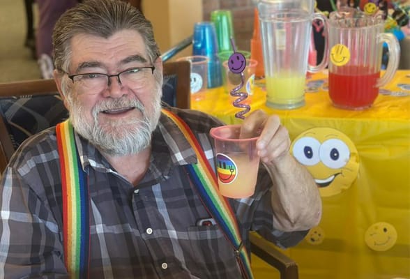 Resident enjoying a colorful drink at an activity event