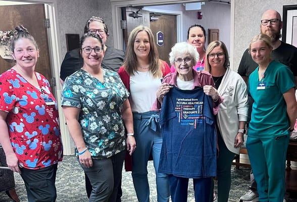 Staff and residents celebrating a graduation at the facility