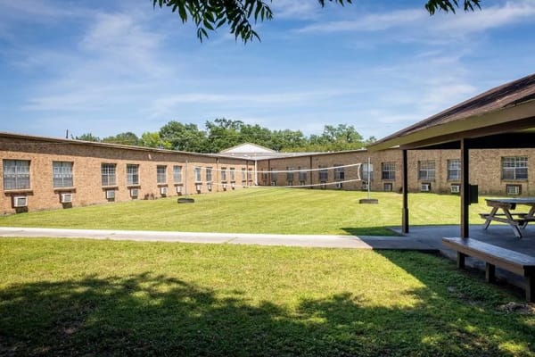Spacious outdoor area with grass and benches