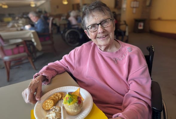 A resident enjoying a meal in the dining room