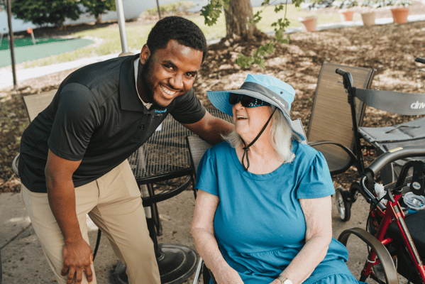Staff member interacting with a resident outdoors