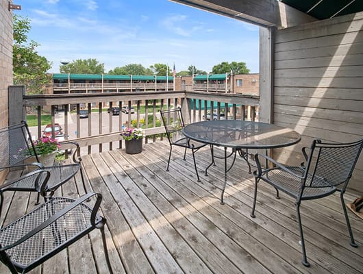 Outdoor patio area with seating and flower pots
