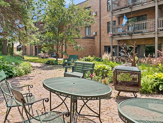 Outdoor seating in a landscaped area of the facility