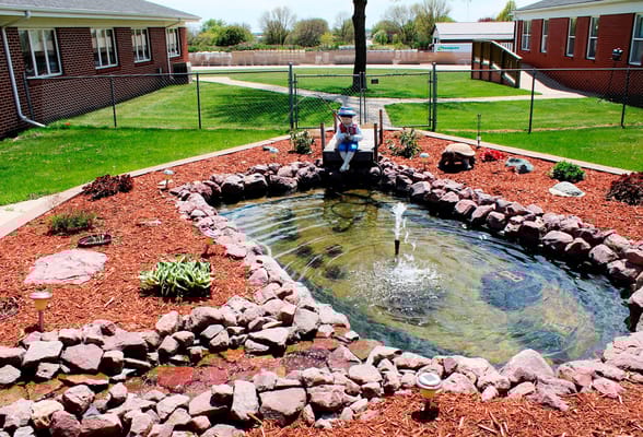 Resident enjoying the garden area by the pond