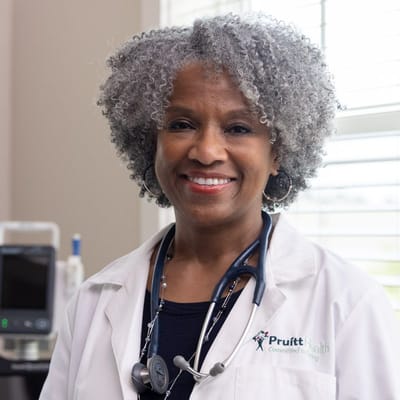 A smiling healthcare professional in a facility