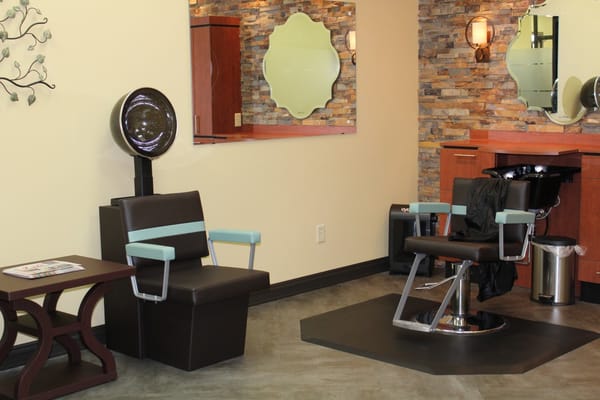 Interior of a salon area with styling chairs and mirrors