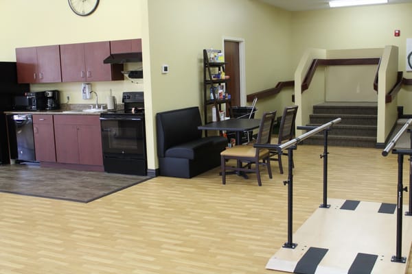 Interior view of a common area with kitchen and seating
