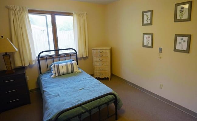 Simple resident room with a bed and dresser