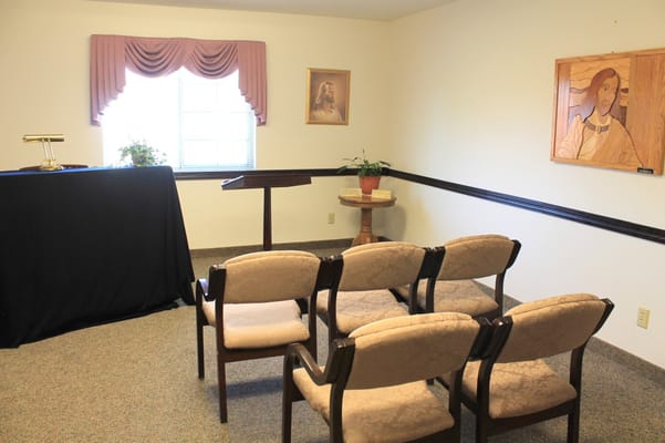 A quiet multi-purpose room with chairs and a podium