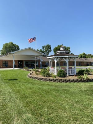 Exterior view of nursing home with gazebo and American flag