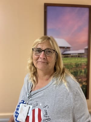 Resident smiling in a brightly lit hallway