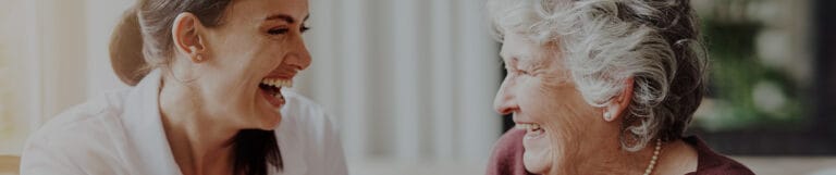 Staff and resident sharing a joyful moment indoors