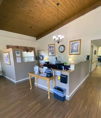Reception area with a wooden ceiling and office desk