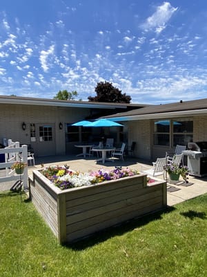 Outdoor seating area with flowers and umbrellas