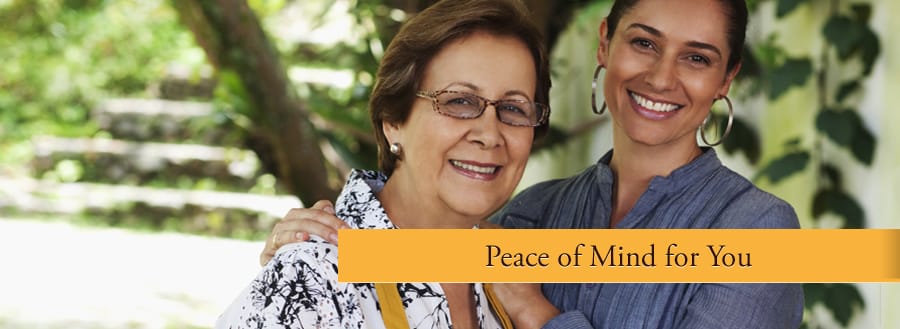 A caregiver with a resident in a garden setting