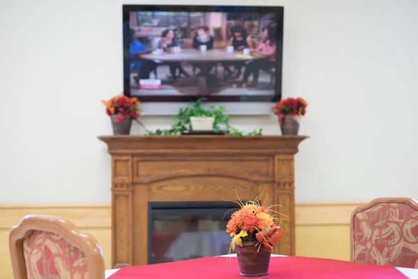 Interior dining area with table and TV in background