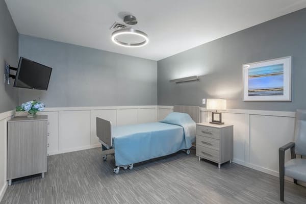 A well-furnished private resident room with bed and decor