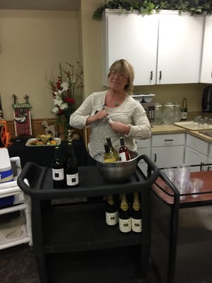 Staff member serving wine in a dining area