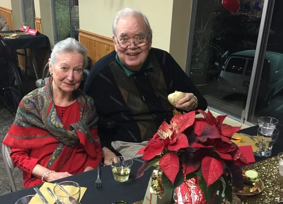 Two residents enjoying a meal together at a festive table