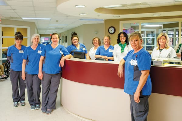 Staff members smiling at the reception area