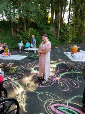 Resident enjoying an outdoor activity with colorful chalk art