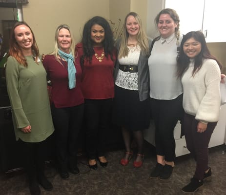 Staff members posing together in a social setting