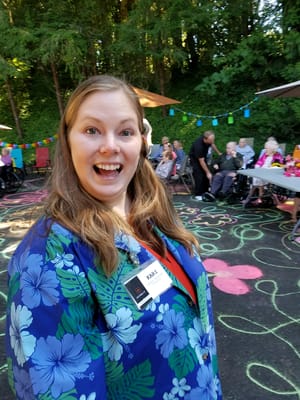 Staff member smiling at a lively outdoor event