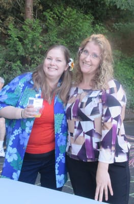 Two staff members posing at a community event