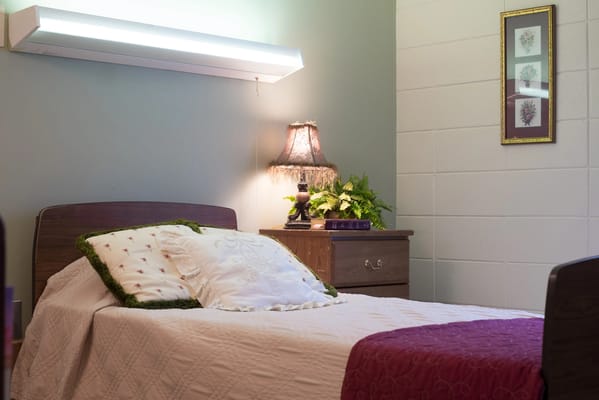 Cozy bedroom with a neatly made bed and lamp